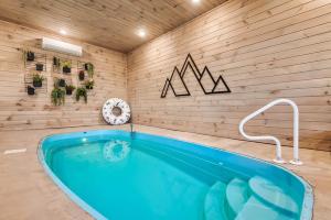 a jacuzzi tub in a room with a wooden wall at Charming Hideaway with Private Pool Hot Tub & Views in Gatlinburg