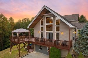 a house with a deck with a gazebo at Cabin Haven Theater Game room Hot Tub Yard in Sevierville