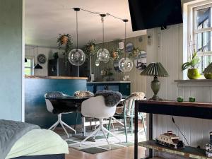 a kitchen with a table and chairs in a room at 8 person holiday home in Gilleleje-By Traum in Gilleleje