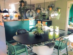 a dining room with a black table and chairs at 8 person holiday home in Gilleleje-By Traum in Gilleleje