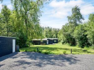 a large yard with a garage and a house at 8 person holiday home in Vig-By Traum in Vig