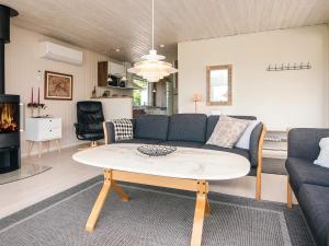 a living room with a couch and a coffee table at 6 person holiday home in Aabenraa-By Traum in Aabenraa +28 photos
