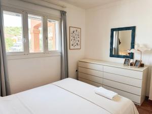 a white bedroom with a dresser and a mirror at Casa Bonita Vista Porto in Santa Teresa Gallura +41 photos