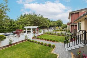 a backyard with a white fence and a garden at Vancouver Cozy Cove in Vancouver