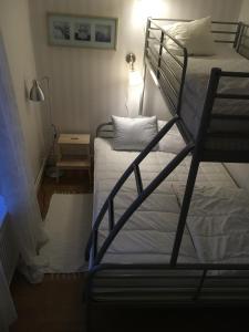 a bedroom with two bunk beds and a lamp at Jaktlyckan, Tuna Gård in Tuna