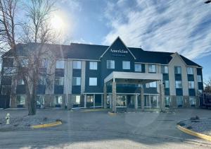 a hotel with a parking lot in front of it at AmericInn by Wyndham, Galesburg, IL in Galesburg