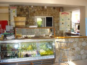 a store with a display of fruits and vegetables at Camping la Clé des Champs in Calvi