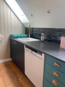 a kitchen with a sink and a counter at Lille Strandbygard in Arnager