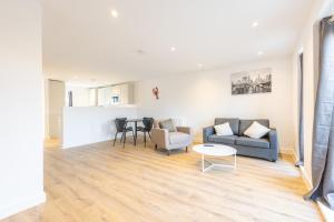 a living room with a couch and a table at Joyful Management - A Mordern Semi-Detached House with 3 bedroom in Manchester