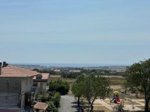 a view of a house and a playground at Lux Villa Silivri Kavakli in Silivri