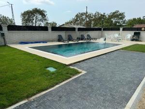 a swimming pool with chairs in a yard at Lux Villa Silivri Kavakli in Silivri +28 photos
