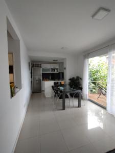 a kitchen and dining room with a table in a room at Departamento En Tigre in Tigre