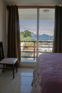 a bedroom with a bed and a large window at Casa Vista Al Sol in Zacatlán +23 photos