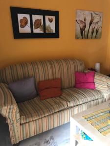 a living room with a couch with colorful pillows at ISLANTILLA - URB GREEN 7 in Islantilla