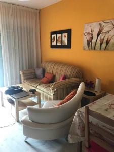 a living room with a couch and a chair at ISLANTILLA - URB GREEN 7 in Islantilla