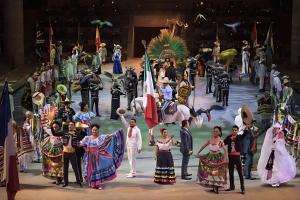 a group of people in costumes on a stage at Coco Zen Studio king size bed sea view near Coco Beach PDC in Playa del Carmen +29 photos