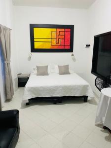 Ένα ή περισσότερα κρεβάτια σε δωμάτιο στο Hotel y centro de convenciones Caney del Ariari