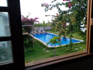 a view of a swimming pool from a window at Villa Bôa Viagem in Fortim +20 photos