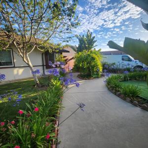 a garden with purple flowers and a house at Cozy & Private Room in Goleta in Santa Barbara