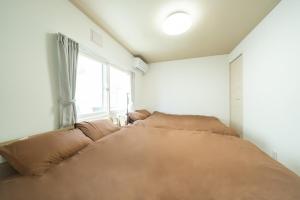 Postel nebo postele na pokoji v ubytování Hachiken House