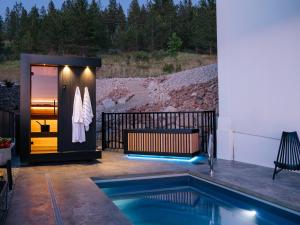 a pool with a hot tub next to a house at Bialto Bed and Breakfast in Penticton