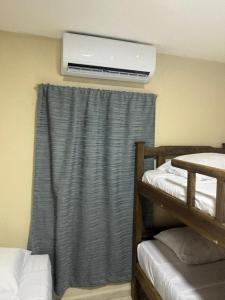 a room with two bunk beds and a air conditioner at Aptos KARS in Ríohacha +12 photos