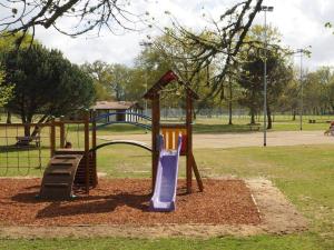 a playground with a slide in a park at Maison Vacances 4 Pers à Pontenx-Les-Forges - Proche Océan et Forêt - FR-1-50-185 in Pontenx-les-Forges +3 photos