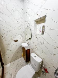 a white bathroom with a toilet and a sink at Visit Chamal - Serenity in Oued Laou +15 photos