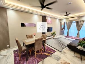 a dining room with a table and a couch at Zyara Homestay Seremban in Seremban