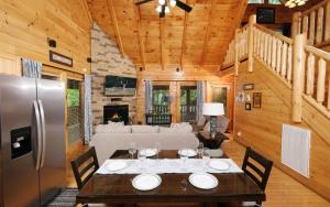 a dining room with a table and a refrigerator at Rockin in the Smokies in Pigeon Forge