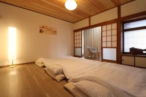 Postel nebo postele na pokoji v ubytování Value Residence Hotel 西之表