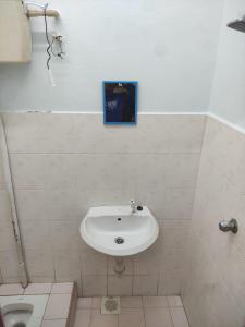 a bathroom with a sink and a toilet at Homestay Melaka Murah in Kampong Bertam