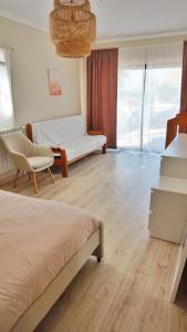 a bedroom with two beds and a chair and a window at Casa Tucano in Aljezur +15 photos