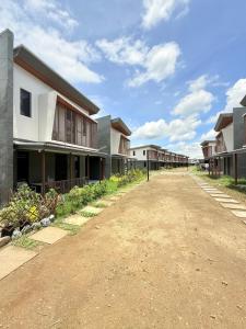 an empty dirt road in front of some houses at 2Js VILLA in Bantug