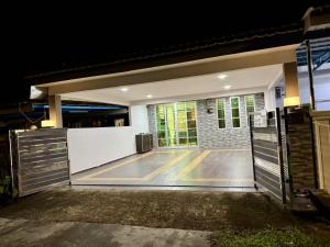 an open garage door with a basketball court at Best Day Homestay ! in Kangar