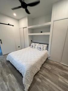 a bedroom with a bed and a ceiling fan at Cute and cosy 1 bedroom cabin in Mooloolah