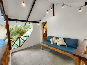 a living room with a blue couch and a window at Manta House - Villa in Town in El Nido