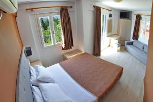 Postel nebo postele na pokoji v ubytování Vliho Bay Boutique Hotel