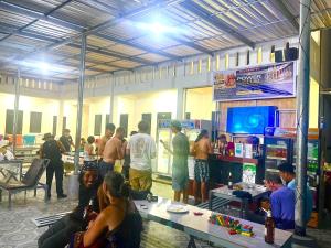 a group of people standing around in a room at Vientiane Apower Hostel & Club in Vientiane