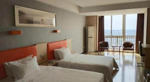 Postel nebo postele na pokoji v ubytování 7 Days Premium Jingjiang Fuhai New World Automobile Terminal Branch + 144 fotografií