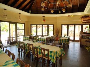 a restaurant with tables and chairs and windows at Agroktima in Mármaron