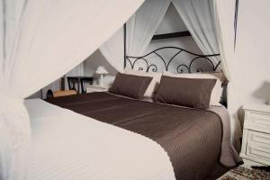a bedroom with a large bed with a canopy at Residenza Bendinelli-Sauli in Genoa