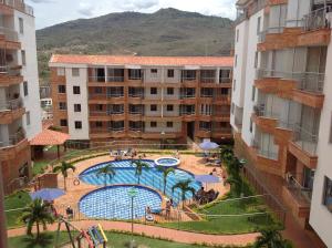 a view of a swimming pool between two buildings at Apto 501 E Alto del Fonce in San Gil