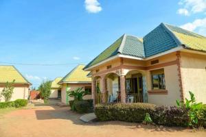 a house with a green roof at Country Side Homes Kasese in Kasese