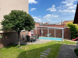 a backyard with a swimming pool and a tree at GP Brno House in Nový Lískovec