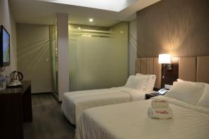 Postel nebo postele na pokoji v ubytování Hotel Trillium