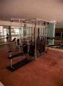 a gym with metal equipment in a room at Habitacion bucaramanga cañaveral piscina parqueadero turco in Floridablanca