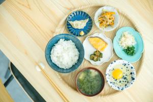 a plate of food with rice and eggs on a table at HINOKINO Hotel in Amakusa