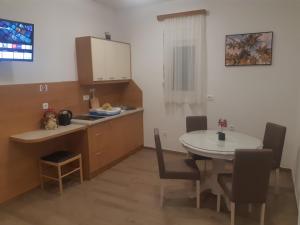 a kitchen and dining room with a table and a table and chairs at Wendy in Budva