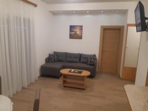 a living room with a couch and a coffee table at Wendy in Budva